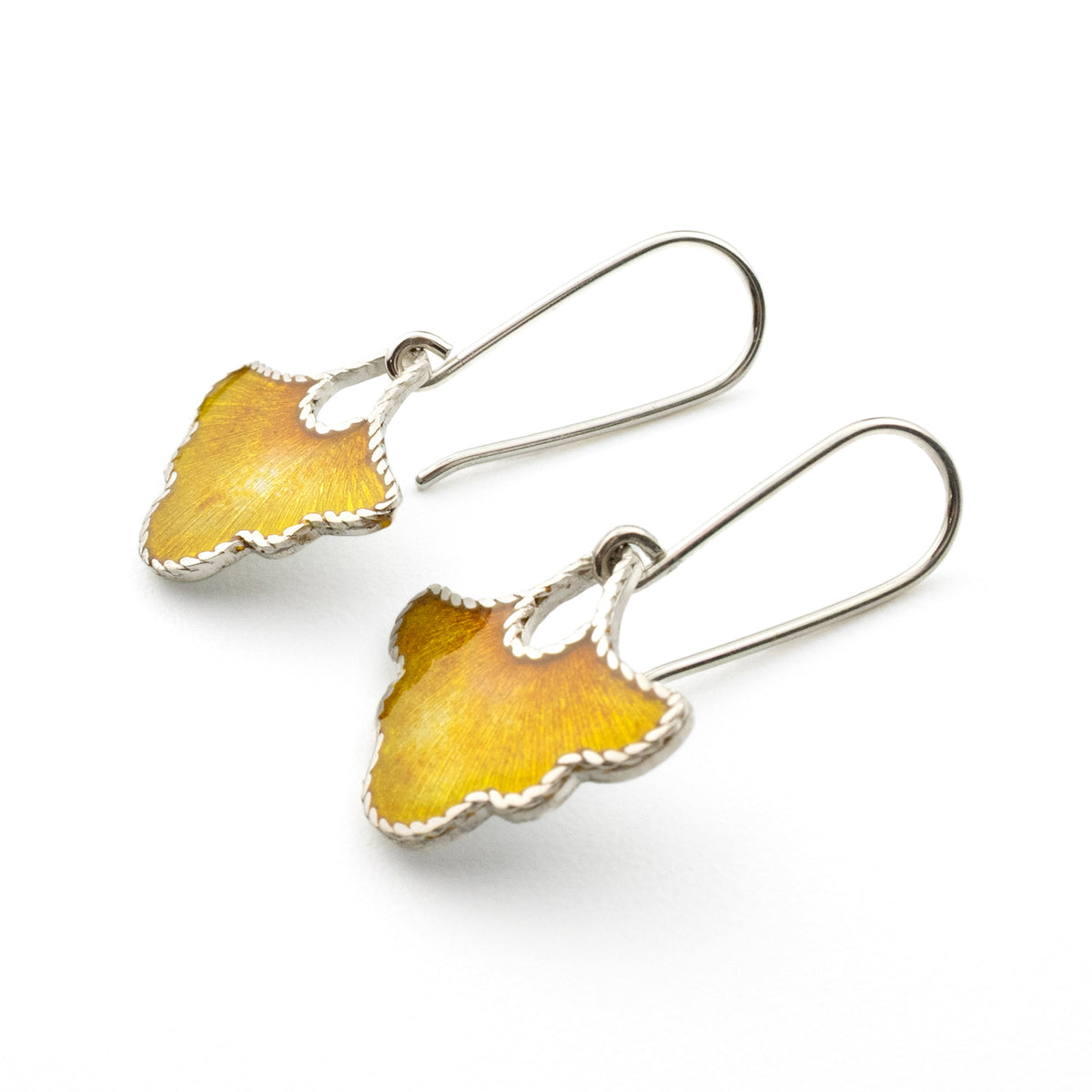 Gilded Petal handmade sterling silver earrings with yellow vitreous enamel displayed on neutral background