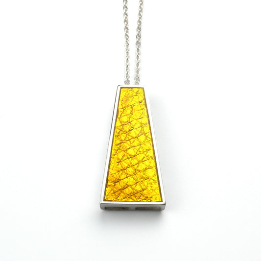 “Handcrafted sterling silver Khorshid Pendant necklace with trapezoid shape, layered yellow vitreous enamel, and subtle texture, suspended on an 18-inch silver chain, reflecting light with a soft luminous glow.”