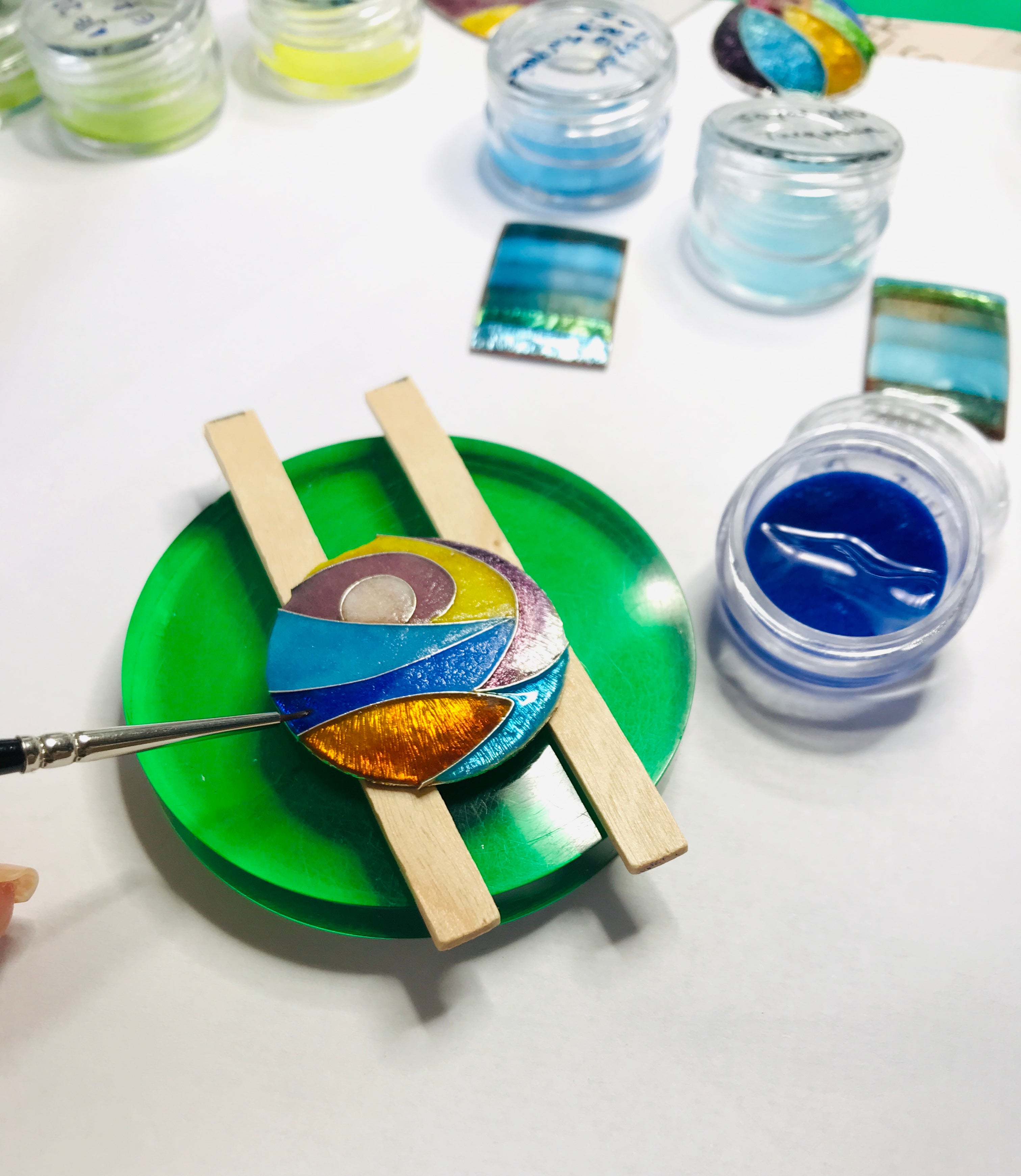 Hand enamelling a cloisonné piece, showcasing the delicate craftsmanship and artistry of Mahroz Hekmati’s unique vitreous enamel techniques.