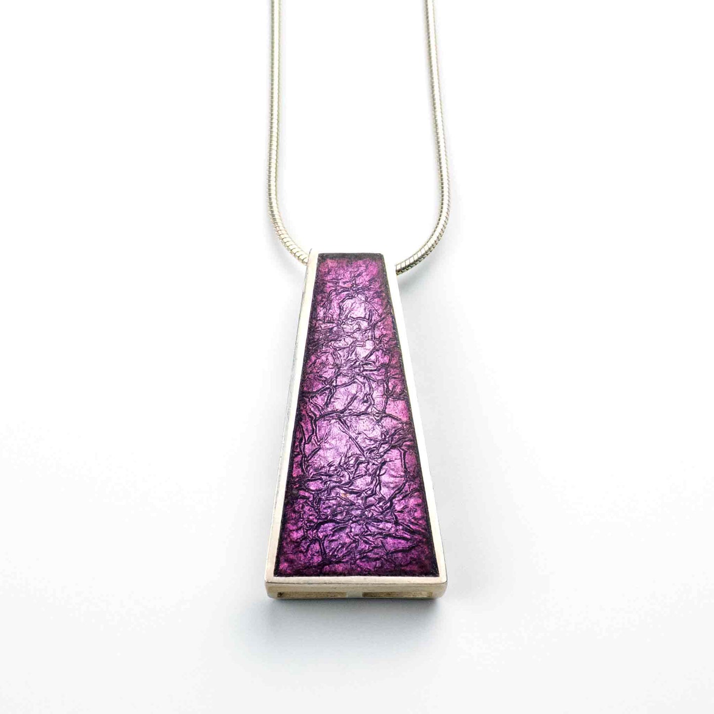 Violet Echo Pendant handcrafted in sterling silver with kiln-fired vitreous enamel in layered shades of purple, featuring a trapezoid shape.